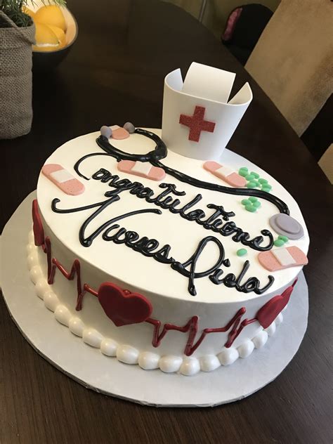 a decorated cake with the words congratulations nurse written on it and medical symbols around it