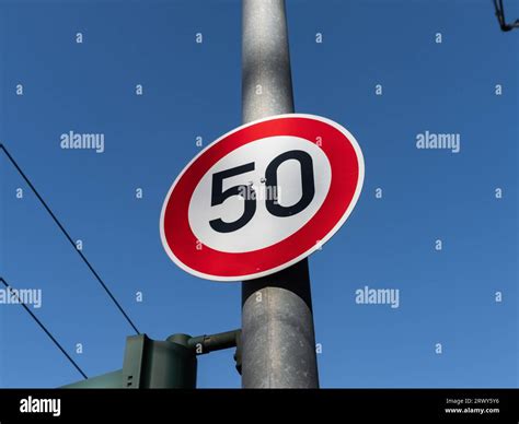 50 kmh speed limit sign on a pole. The traffic sign forbids car drivers to go faster than fifty ...