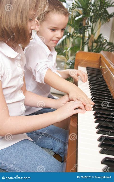 Children Playing The Piano Stock Photo - Image: 7659670