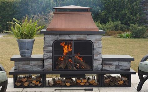 A wood-burning outdoor fireplace placed on a concrete patio. | Outdoor ...