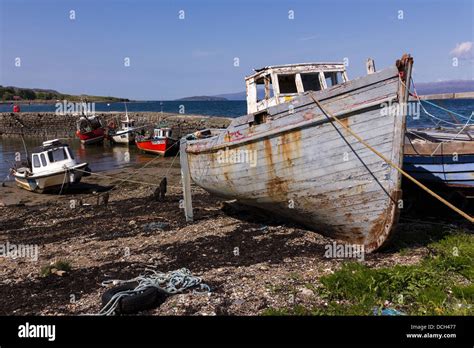 Old carvel-built wooden fishing boat and moored boats at Broadford Stock Photo: 59383499 - Alamy