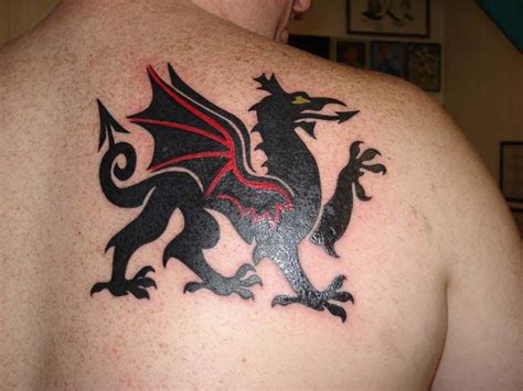 My husband's first tattoo. Got this with his brother at the same time. It's Welsh dragon to ...