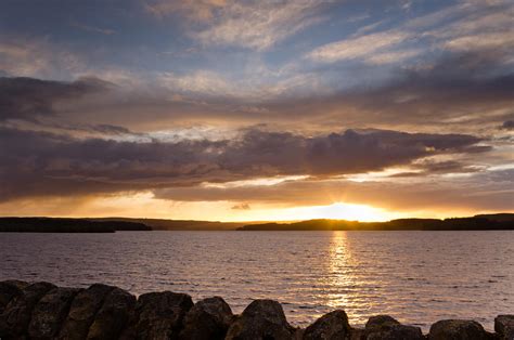 Sun sets on Kielder reservoir Photograph by David Head - Fine Art America