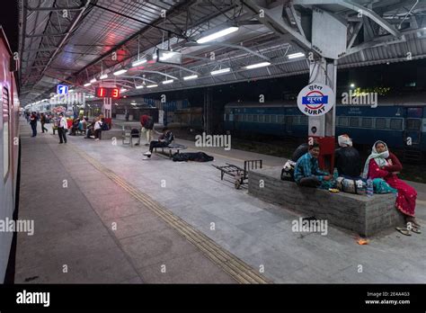 Night scene of Surat Railway Station with people waiting to board their ...