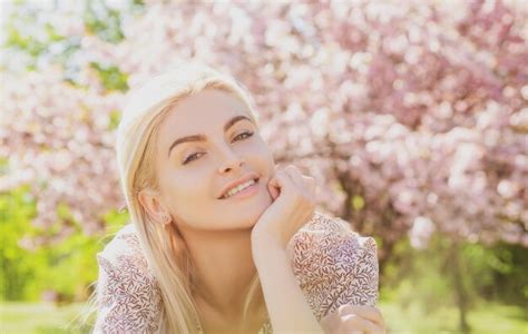 Premium Photo | Happy girl with flowers in grass cute face of smiling ...