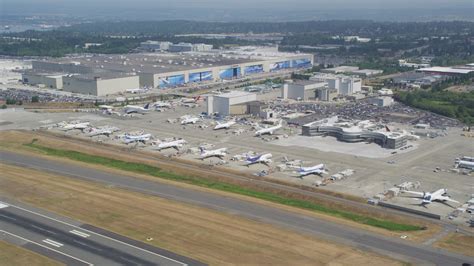 5K stock footage aerial video of Boeing Everett Factory and rows of ...