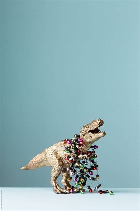 "Dinosaur Struggling With Christmas Lights" by Stocksy Contributor "Ruth Black" | Dinosaur ...