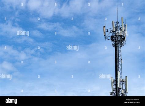 Telecommunication tower with blue sky and white clouds background ...