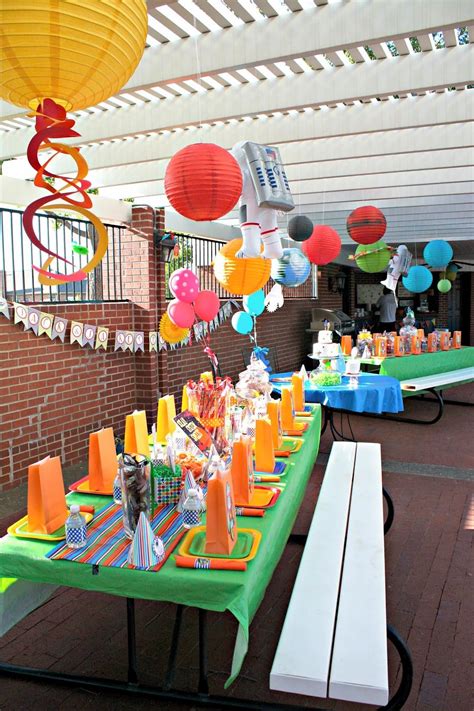 Hanging planets with paper lanterns. Also a lot of good food ideas here: Moon pies, starburst ...