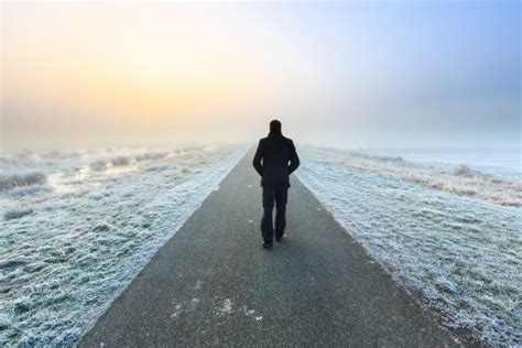 Man walking on an empty desolate raod - Stock Image - Everypixel