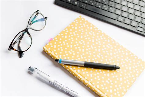 Office table with notebook, computer and reading glasses - Creative ...