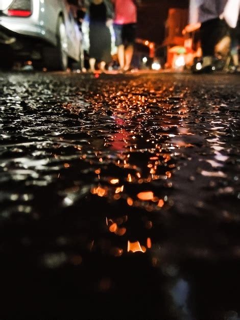 Premium Photo | Defocused of road after rain with reflection of car headlights