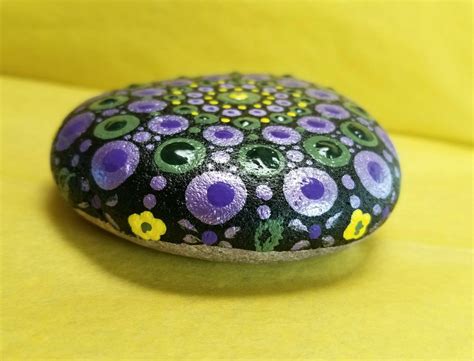 Mandala - metallic purple, green, yellow. Side view called flowers and feathers | Mandala rocks ...
