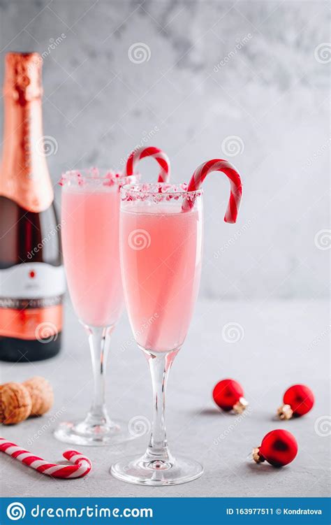 Festive Christmas Drink Peppermint Bark Mimosa Cocktail with Champagne or Prosecco and Candy ...