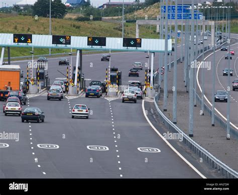 M6 TOLL MOTORWAY ROAD from above with cars approaching toll booths West Midlands England UK ...