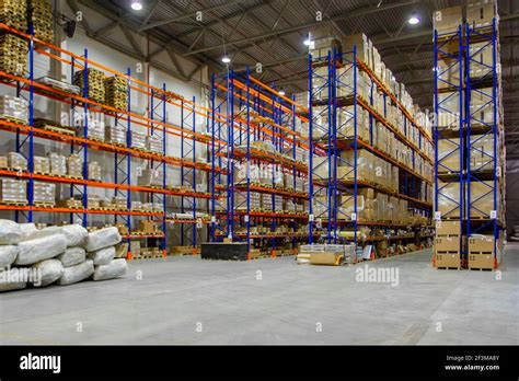 Interior of a modern warehouse storage of retail shop with pallet truck ...