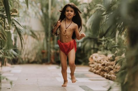 Premium Photo | Mowgli indian little girl in a loincloth hides hiding ...