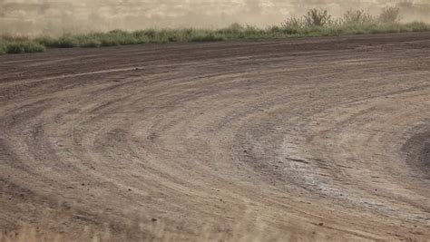 Race Cars On A Dirt Track: Racing Crews In The Background Stock Footage ...