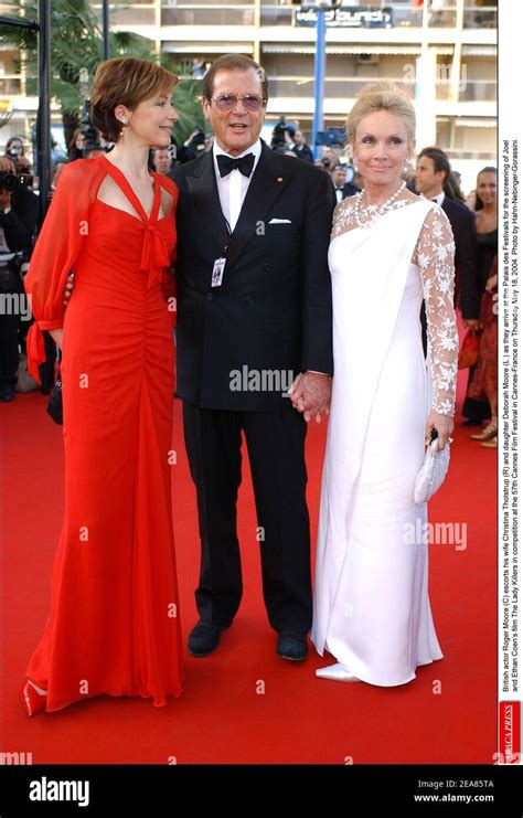 British actor Roger Moore (C) escorts his wife Christina Tholstrup (R ...