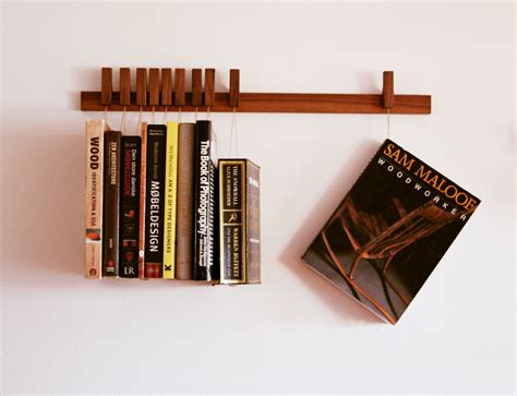 Custom made wooden book rack / bookshelf in Walnut. Pins also