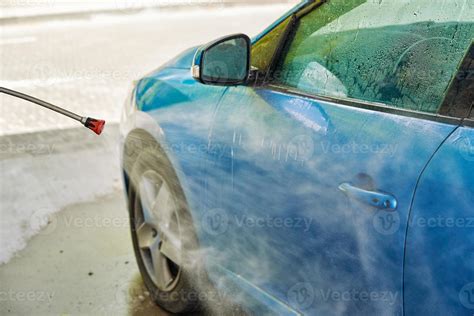 Cleaning car with high pressure water at car wash station 21016350 ...