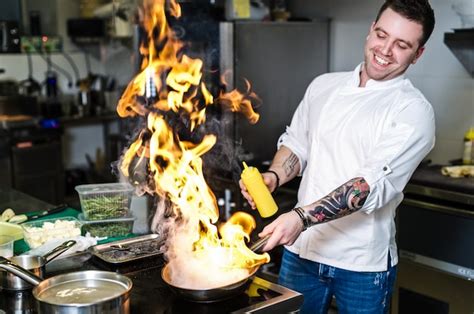 Premium Photo | Chef is making flambe in a restaurant kitchen