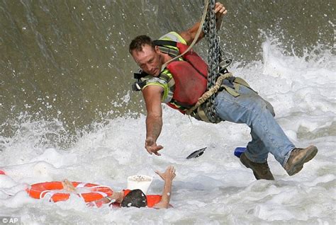 The moment construction worker dangled from a crane to pluck drowning ...