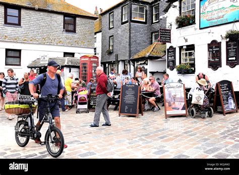 St. Ives, Cornwall, UK. June 30, 2019. Diners eating and drinking alfresco at the Sloop Inn on ...