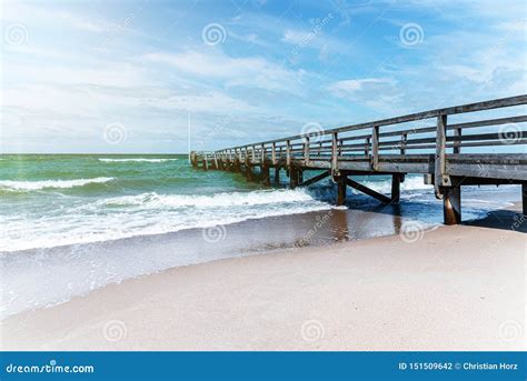 Wooden Pier on Beach Against Ocean and Blue Summer Sky Stock Photo ...