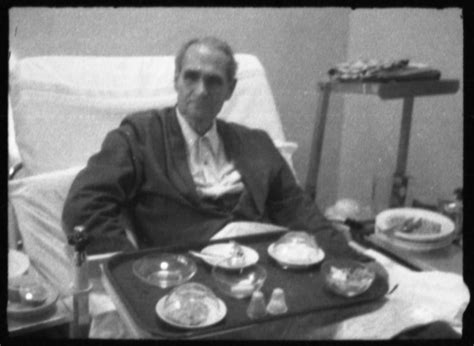 Clandestine photographs of Rudolf Hess sitting in his hospital bed with his tray of food in the ...