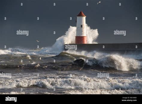 Lighthouse in stormy sea Stock Photo - Alamy