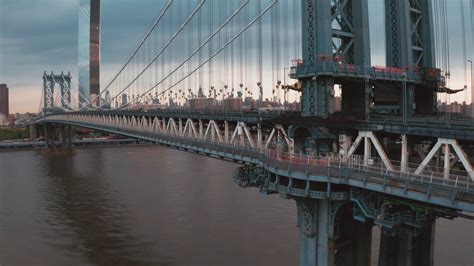 Aerial view of Manhattan Bridge structure and New York city at sunrise ...