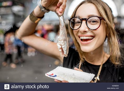 Woman with dutch herring Stock Photo - Alamy