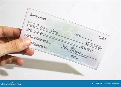 Holding a Million Dollar Bank Check Isolated in a White Background ...