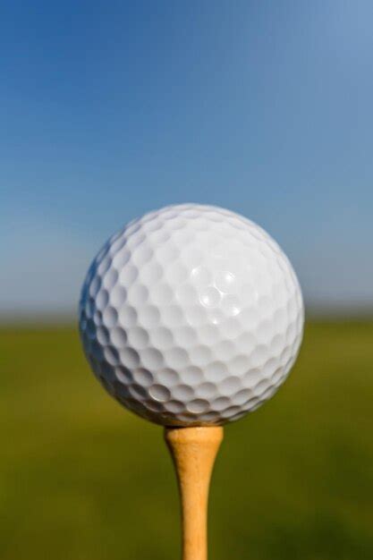 Premium Photo | Golf ball on tee close up