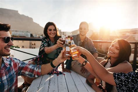 Friends Toasting Drinks at Rooftop Party Stock Photo - Image of female, success: 93899006