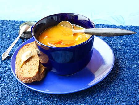 Dinner from pumpkin soup and slice of bread with the lobule of garlic - Stock Image - Everypixel