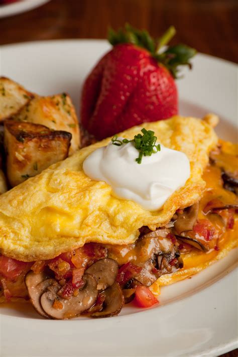 Applewood Smoked Bacon Omelet: 3 eggs, bacon, mushrooms, tomato, tillamook cheddar-sour cream ...