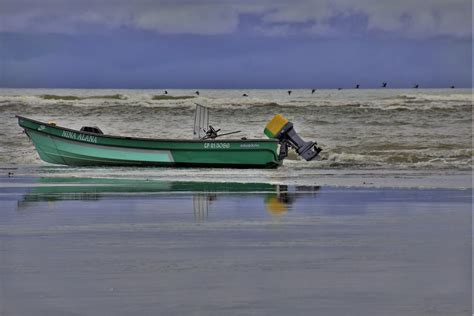 Green Fishing Boat on Seashore · Free Stock Photo