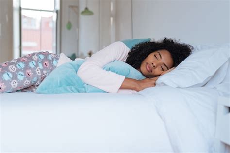 Premium Photo | Happy beautiful young black woman lying down in the bed sleeping