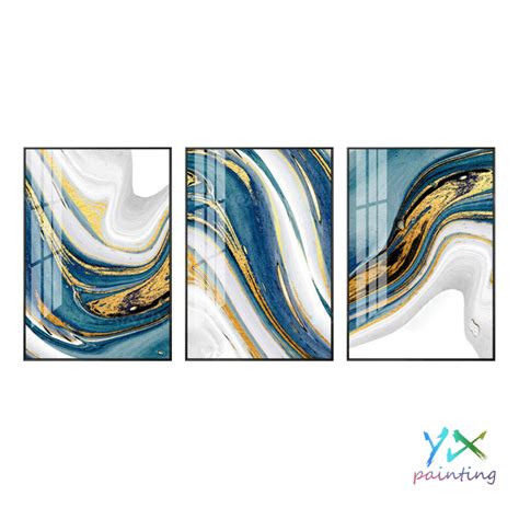 three abstract paintings with blue, white and gold colors