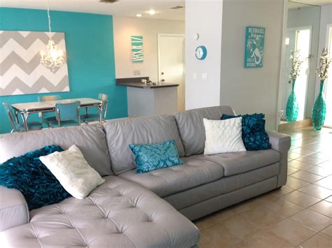 Florida home. Beach house. Leather couch. Homemade art. Tan and teal living room. #Livingroomd ...