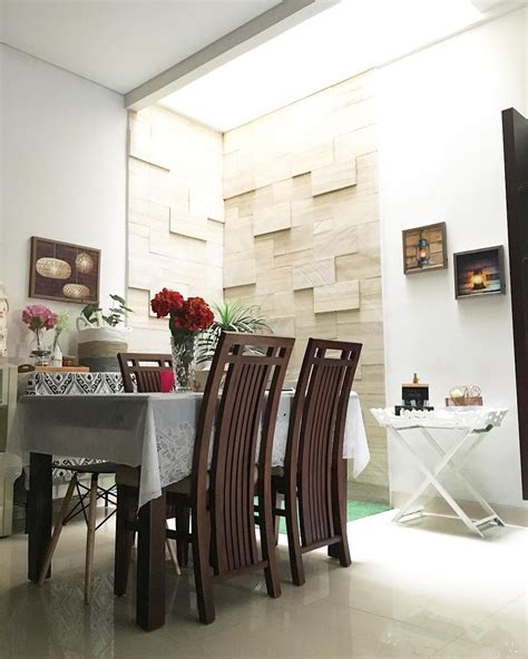 a dining room table and chairs with flowers in vases