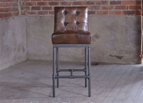 The Nungan Vintage Leather Bar Stool has a traditional look with a ...