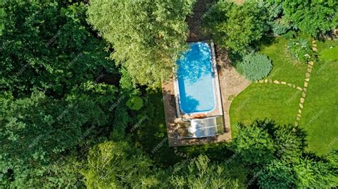 Premium Photo | Swimming pool in beautiful garden aerial top view from ...