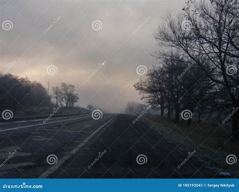 A Foggy Dark Road with the Sun on the Horizon Stock Image - Image of cloud, sunlight: 185193043