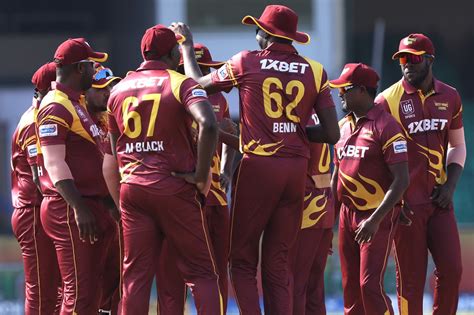 The West Indies players get together to celebrate a wicket ...