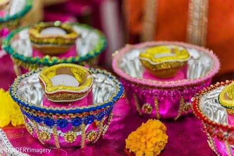 colorful glass dishes with decorative designs on them sitting on a pink cloth covered tablecloth