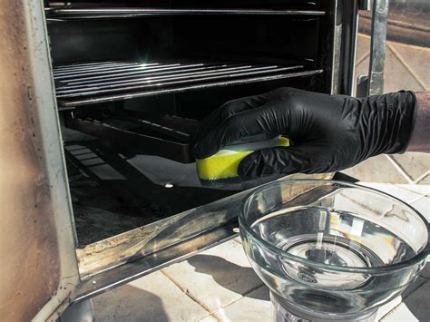 Cleaning the electric smoker oven with sponge and black gl… | Flickr