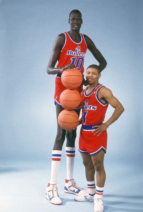 Manute Bol, the tallest player in NBA history at 7'7", next to Muggsy ...